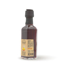 Condimento al Peperoncino - Bottiglia di olio extravergine di oliva rosso intenso con peperoncino. Formato 10 cl - vista laterale.