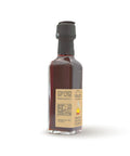 Condimento al Peperoncino - Bottiglia di olio extravergine di oliva rosso intenso con peperoncino. Formato 10 cl - vista laterale.