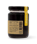 Retro del vaso da 100 grammi di Confettura di Uva Fragola Scalzo Calabria, con lista ingredienti.